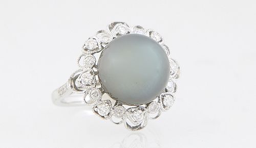 Lady's 18K White Gold Dinner Ring, with a black 12mm Tahitian Cultured Pearl, atop a pierced border of round diamonds, the shoulders of the band also 