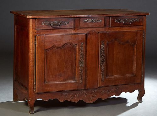 French Provincial Louis XV Style Carved Cherry Sideboard, 19th c., the ogee edge canted corner rectangular top above three frieze drawers, over double