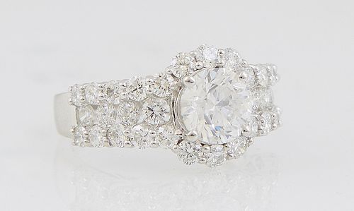 Lady's Platinum Dinner Ring, with a round 1.69 carat diamond, atop a diamond mounted border and shoulders of the band, total diamond accent wt.- 1.87 