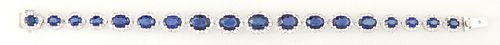 14K White Gold Link Bracelet, each of the 18 oval inks with a graduated oval blue sapphire atop a border of tiny round diamonds, total sapphire wt.- 1