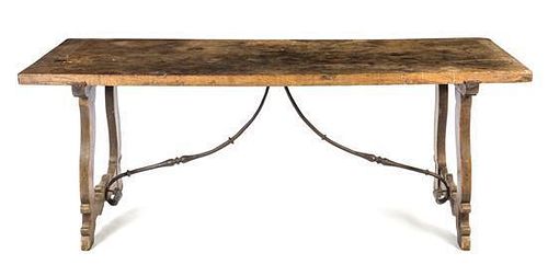 A Spanish Baroque Walnut and Iron Trestle Table Height 29 1/2 x width 77 x depth 27 inches.