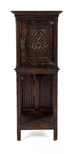A Gothic Revival Oak Cabinet Height 50 1/4 x width 18 5/8 x depth 15 3/4 inches.