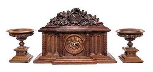 A Continental Carved Oak Three-Piece Clock Garniture Height of clock 15 1/2 inches.