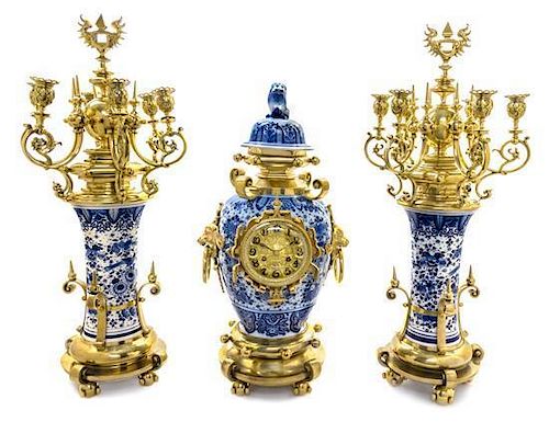 A Gilt Metal Mounted Delft Clock Garniture Height of candelabra 24 inches.