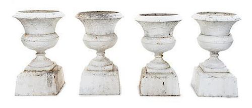 A Set of Four Victorian Iron Garden Urns Height 33 inches.