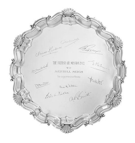 An Edward VII Silver Salver, Mappin & Webb, London, 1901, the undulating border with rocaille decoration and raised on three cla