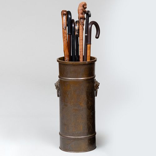 Group of Seven Wooden Canes and a Hammered Brass Umbrella Stand 