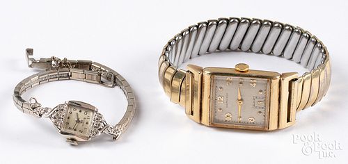 Two wristwatches, with 14K gold cases.