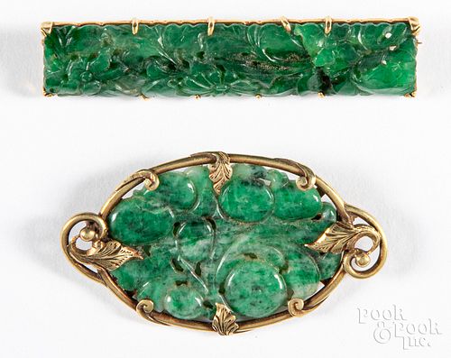 Two 14K gold and jade pins.
