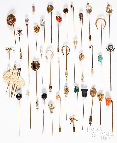 Collection of gold and plated hat pins.