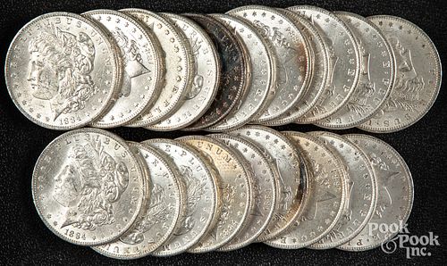 Twenty 1884-O Morgan silver dollars.