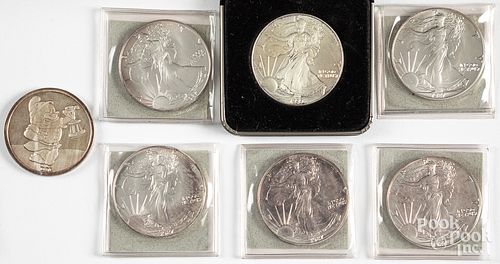 Seven 1 ozt. fine silver coins.