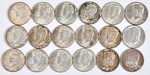 Eighteen 1964 Kennedy silver half dollars.