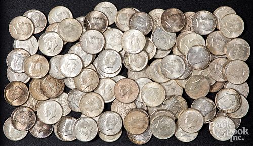 One hundred 1964 Kennedy silver dollars.