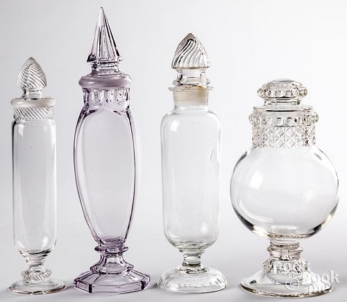 Four glass apothecary jars