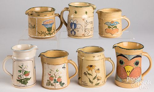 Seven Left Handed Russell Henry cream pitchers