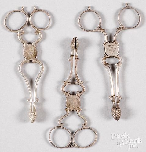 Three English silver scissor sugar tongs, 18th c.