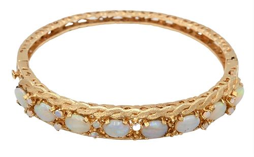 14K Gold Bangle Bracelet, set with opals, three small opals missing, 21.1 grams.