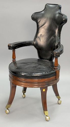 Continental style leather swivel office chair on mahogany base.
