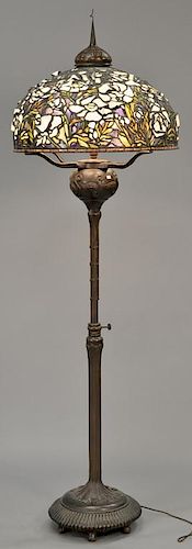 Tiffany style floor lamp with leaded shade and bronze base. ht. 84 in.; shade dia. 27 in.