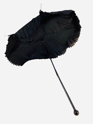 Old doll parasol made from black silky material w/ articulated wood handle allowing shortening, approximately 22" wide when opened. Fabric has wear, s