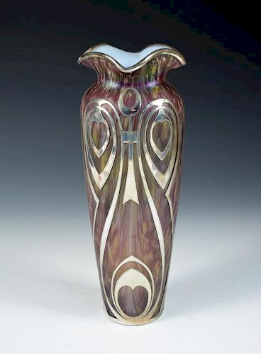 An Art Nouveau style iridescent glass vase with silver overlay, the slender form with flared rim, un