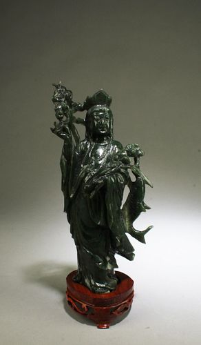 A Carved Spinach Jade Guanyin Statue