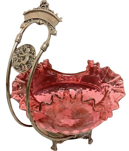 Unusual vintage cranberry glass basket in arched metal holder featuring a cherub. Glass bowl has a chip to bottom, does not go thru glass. Metal holde