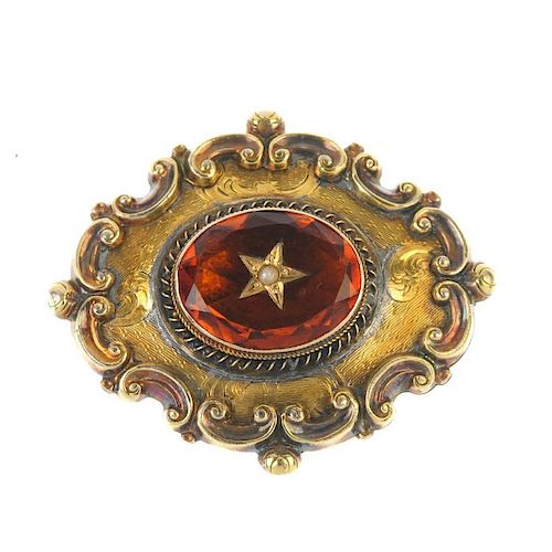 A late Victorian gold brooch. The central oval-shape citrine with star set with split pearl to its c