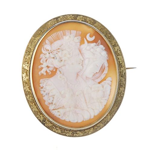 A shell cameo brooch depicting Night and Day. The shell with Night or Nyx and Day or Eos, with an ea