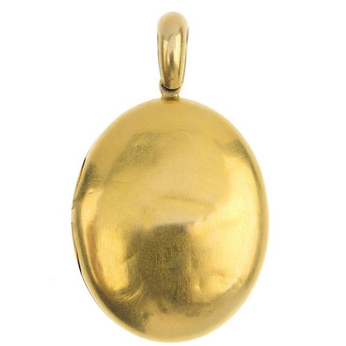 A mid Victorian 18ct gold locket, circa 1870. The oval-shape locket, suspended from a tapered surmou