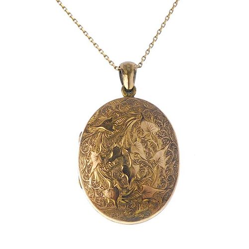 A gold front and back locket. Of oval-outline, the front and back with ivy engraving, opening to rev