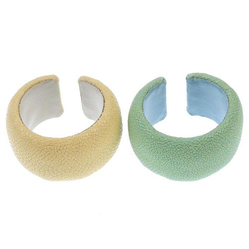 Two stingray cuffs. The two cuffs, one of pale yellow, the other of mint green, to the leather linin