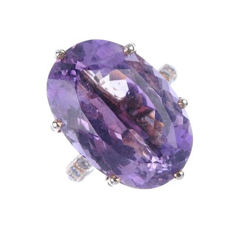 Two items of gem jewellery. The first an amethyst ring, the oval-cut amethyst claw-set to the should