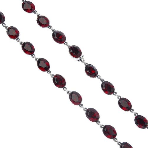 A paste necklace. Designed as a series of oval-shape red paste collets, to the similarly-designed pa