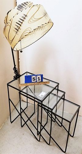 MID CENTURY WROUGHT NEST OF 3 TABLES W/ GLASS TOPS AND LG ONE HAS ATTACHED LAMP 21"H X 12 1/2"W X 16 1/2" W/ LAMP 4'H