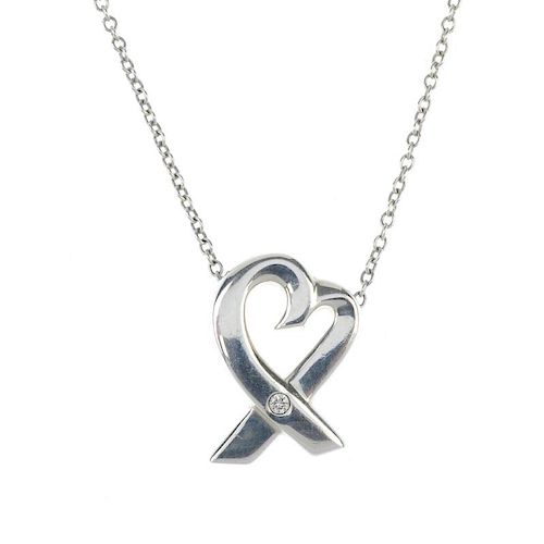 TIFFANY & CO. - a diamond set pendant. The fine-link chain suspending a heart shape crossing over to
