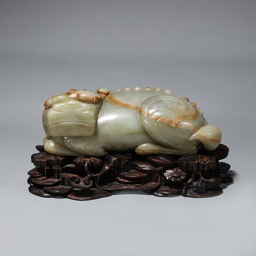 A jade beast ornament with a pedestal
