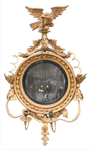 Fine Classical Carved Giltwood Girandole Mirror, Philadelphia, circa 1815, flat circular mirror plate, ebonized slip surround by a framework hung with