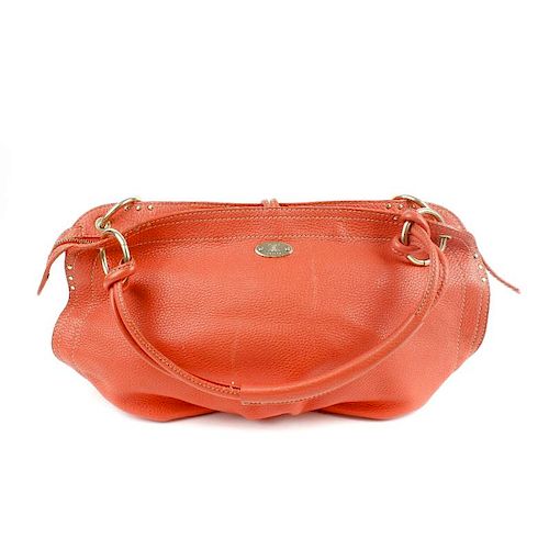CELINE - a coral leather Bittersweet hobo. Designed with a soft pebbled leather exterior, pale gold-