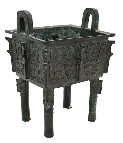 Chinese Bronze Ding, four footed rectangular ritual vessel having opposing loop handles, exterior decorated with a Taotie mask and the interior with a