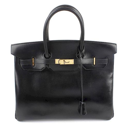 HERMES - a 35cm Birkin Bag. Featuring a smooth black leather exterior, dual rolled handles, top flap