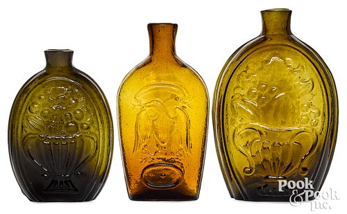 Three olive and amber glass flasks 19th c.