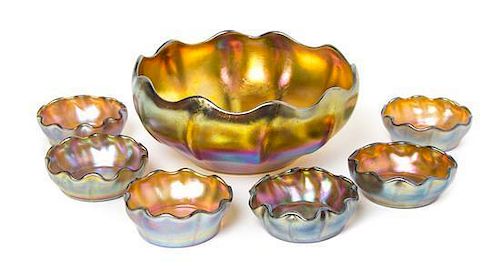 A Tiffany Studios Gold Favrile Glass Bowl and Six Salt Cellars, Diameter of bowl 6 1/4 inches.