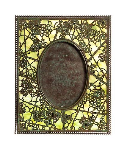 A Tiffany Studios Bronze and Favrile Glass Picture Frame, Height 10 inches.