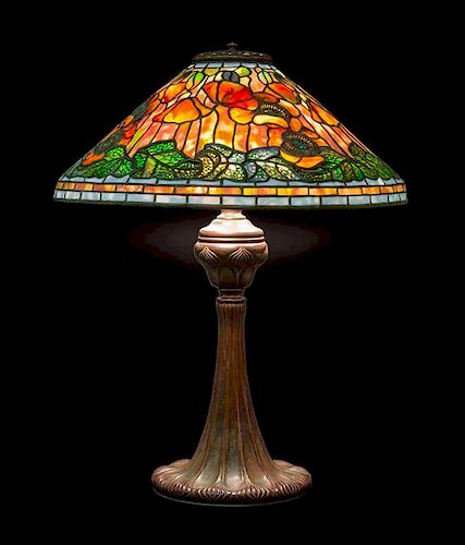 A Tiffany Studios Favrile Glass and Bronze Poppy Lamp, Height overall 26 1/4 x diameter of shade 20 inches.