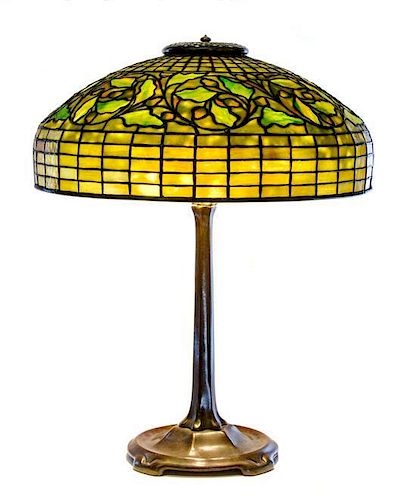 * A Tiffany Studios Favrile Glass and Bronze Swirling Oak Lamp, Height overall 22 1/2 x diameter of shade 18 inches.