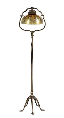 A Tiffany Studios Gold Favrile Glass and Bronze Floor Lamp, Height overall 58 x diameter of shade 12 inches.