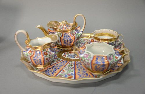 Six piece French porcelain tete-a-tete tea set to include sugar, creamer, small pot, cup, saucer, and tray. lg. 13 1/2 in.