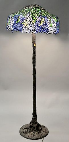 Leaded glass floor lamp with bronze base. ht. 67 in.; shade dia. 18 in.